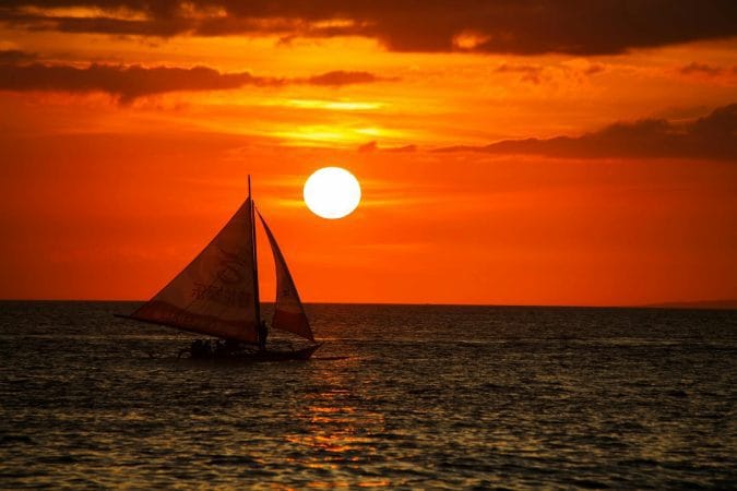 Full Sunset over Boat on Sea