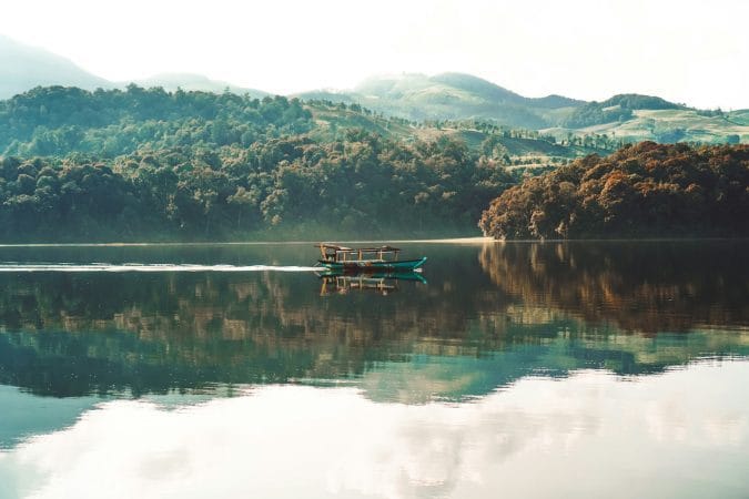 boat on calm body of water at daytime