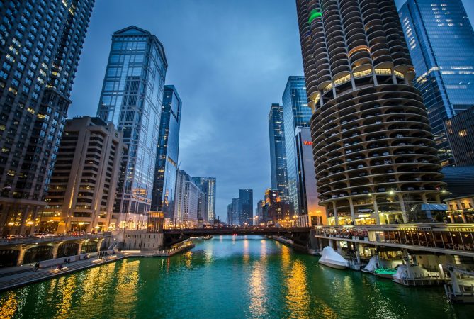 a river running through a city next to tall buildings